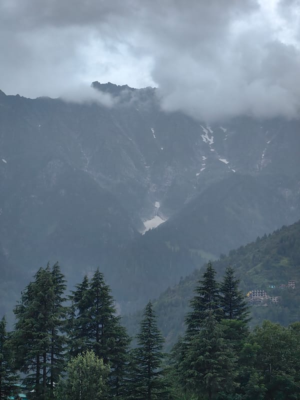 Misty Himachal valley: mountain infrastructure and cloud-covered peaks