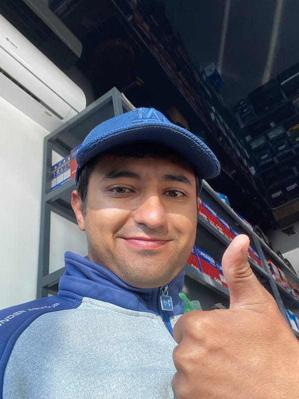Customer poses with thumbs up at Bukhara auto parts store