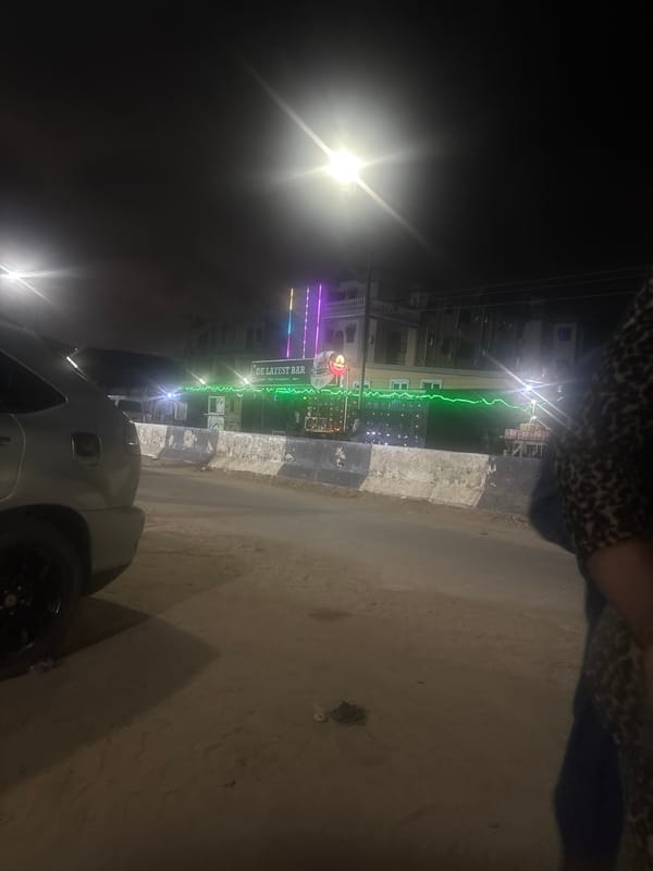 Colorful nighttime lighting observed at bar in Satellite Town