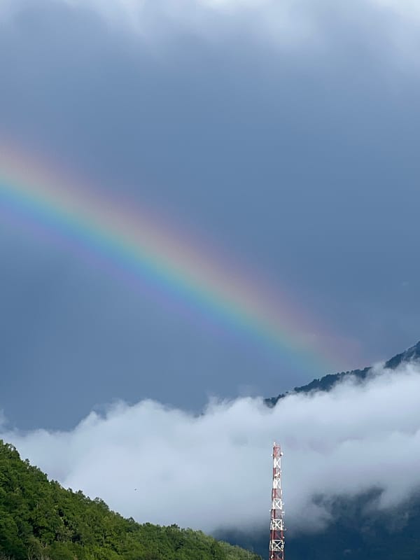 Rainbow over Krasnaya Polyana's mountain slopes after a storm