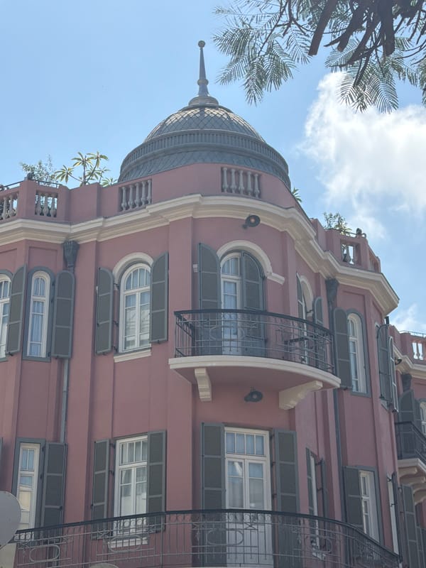 Street musician performs in Tel Aviv amid distinctive architecture