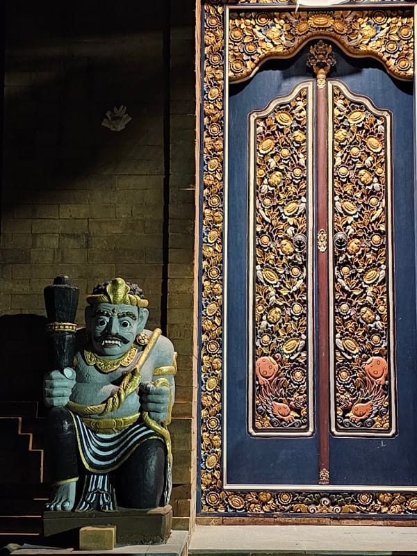 Temple architecture documented in nighttime Denpasar street scenes