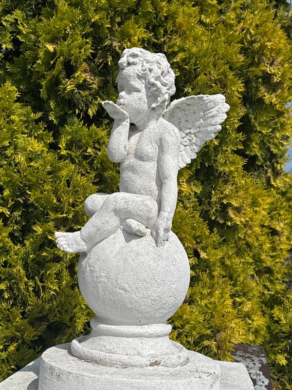 Cherub statue and decaying garage door in Bagrationovsk