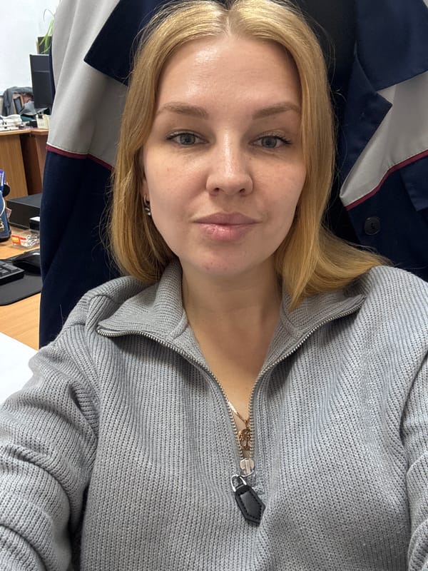 Woman takes selfie in gray sweater in Rusanovo