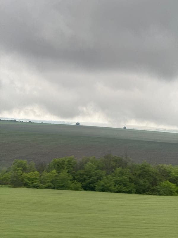 Rural Bulgarian countryside observed under cloudy morning skies