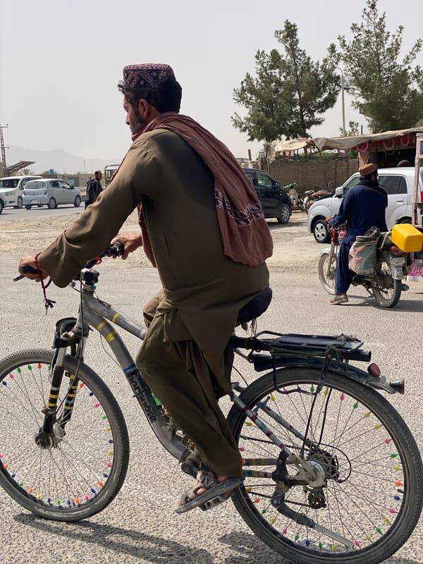 Kandahar street life: vendors, cyclists, and utility vehicles
