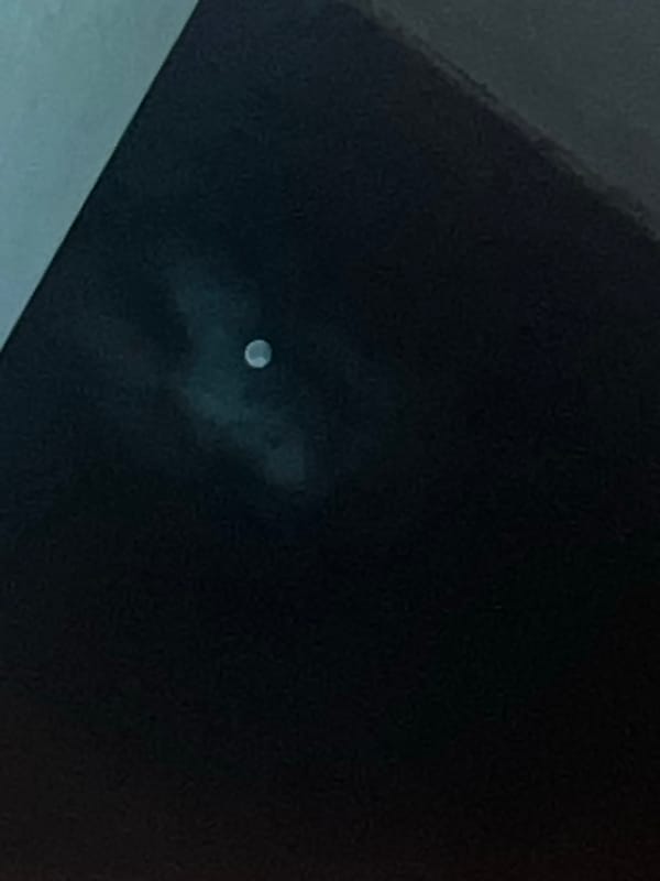 Full moon spotted through clouds over Sofia, Bulgaria