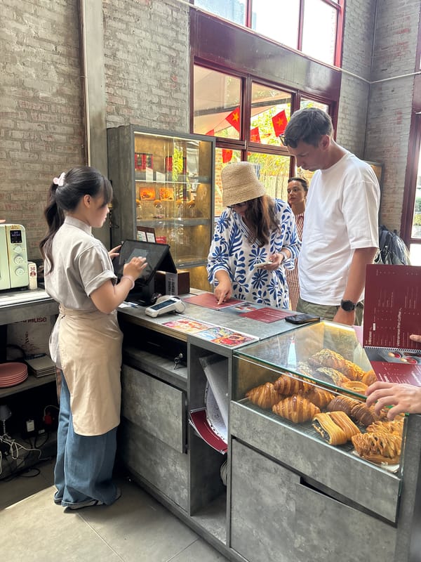 Inside a Đà Nẵng café: coffee, counter service, industrial space