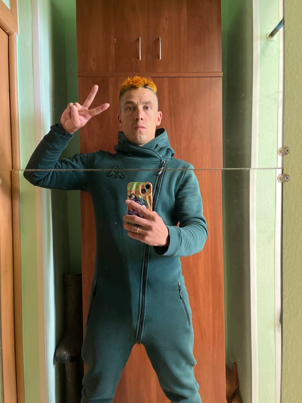 Man takes mirror selfie in jumpsuit in Chaikovsky