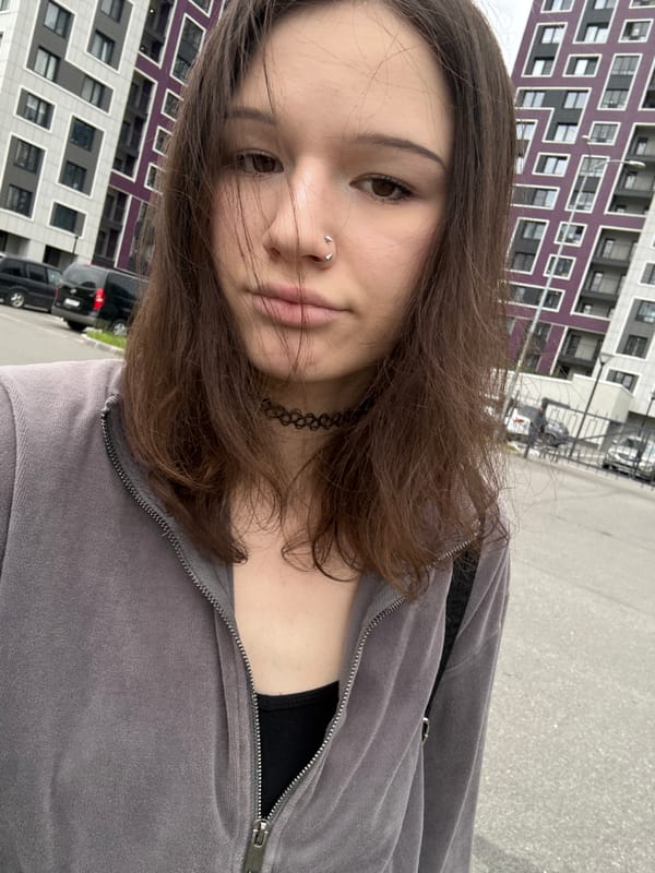 Woman takes selfies outside apartment building in Kokkorevo