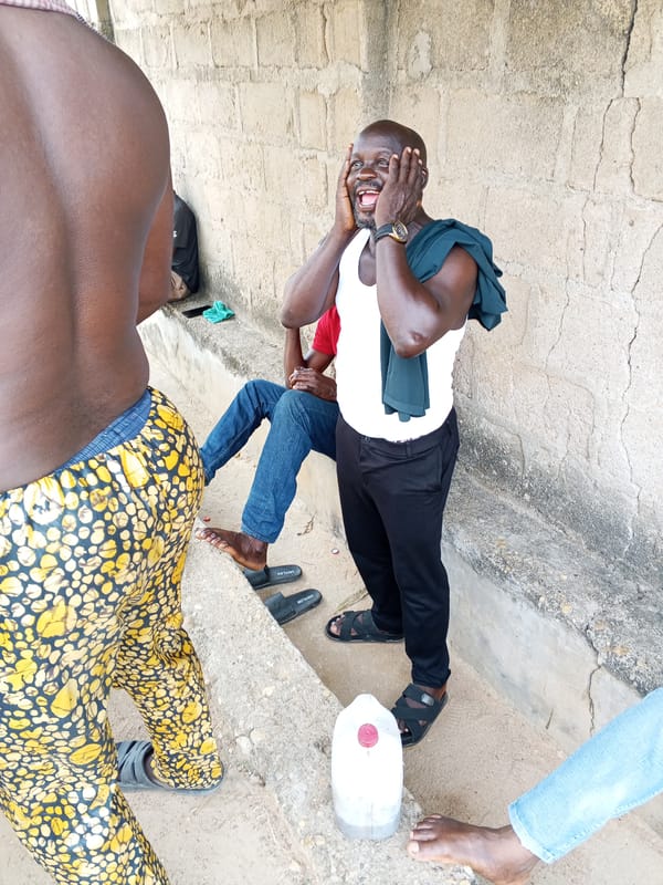 Men gather for casual outdoor socializing in Nigerian communities