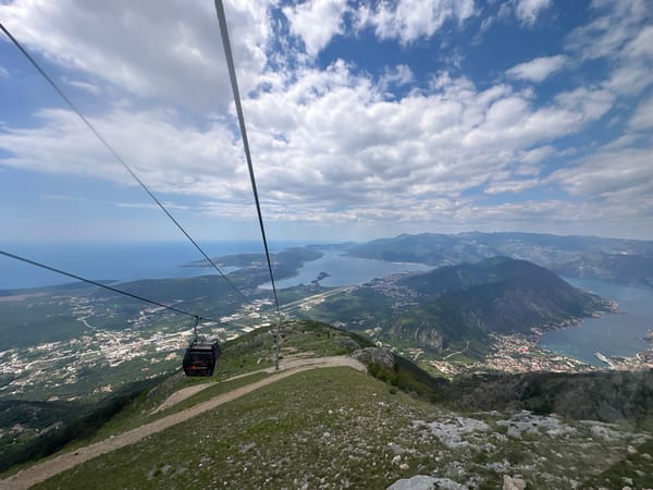 Cable car passengers capture scenic views of Kotor Bay, Montenegro