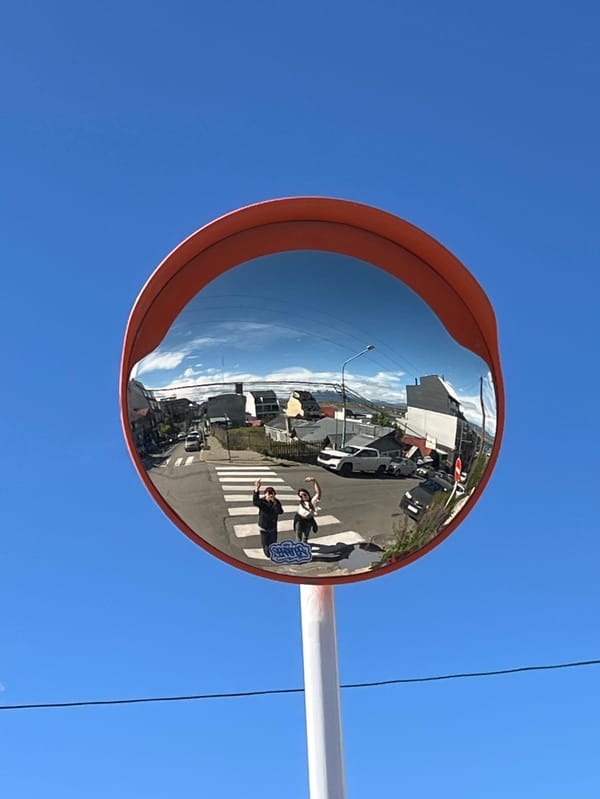 Traffic mirror captures everyday street crossing in Ushuaia