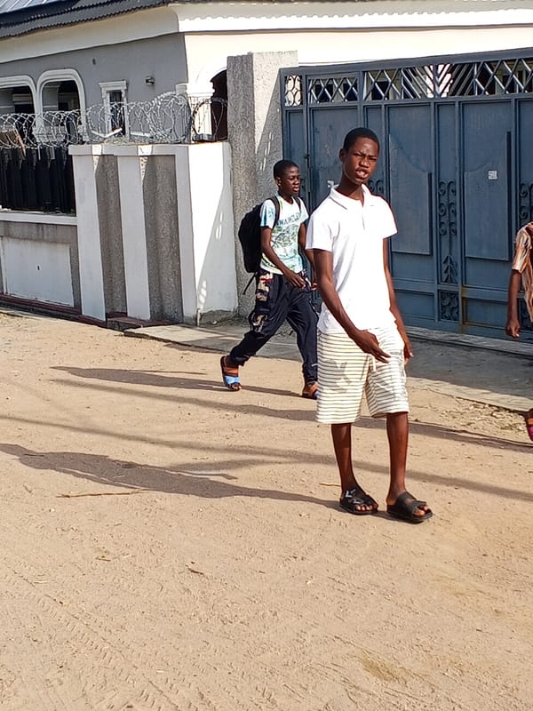 Residents walk unpaved roads in Adonkolo Nigeria morning