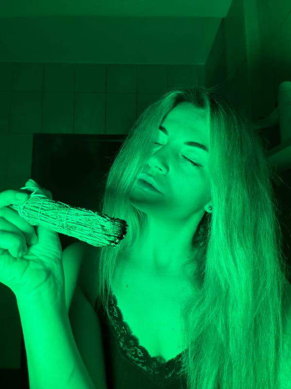 Woman conducts sage burning ritual in Budva bathroom
