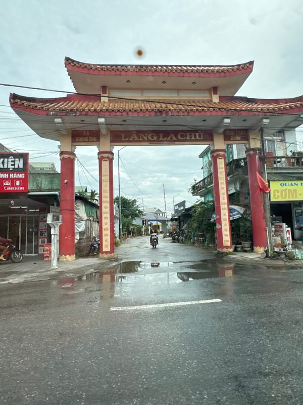 Traditional red and gold gate marks a road in Kim Trà Ward