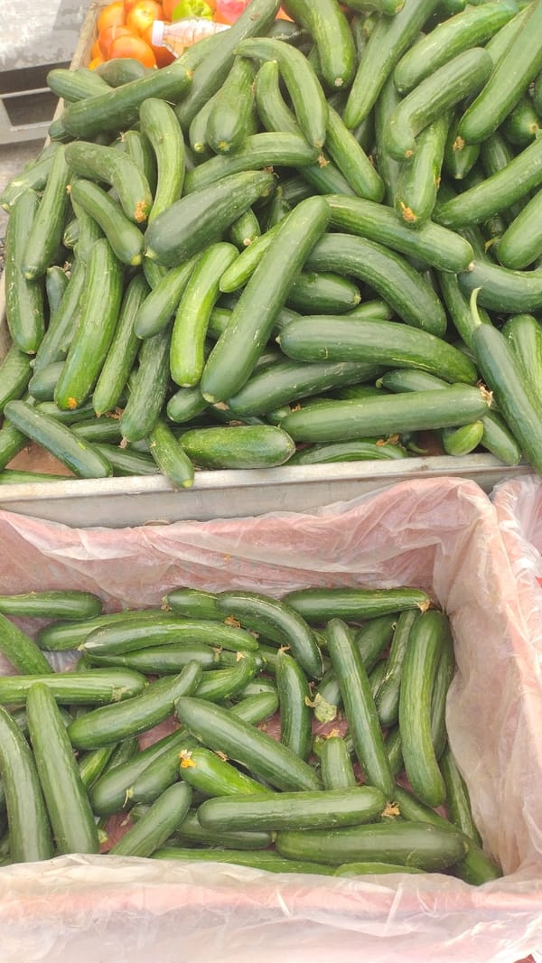 Morning street market bustling with fresh produce in Perea, Greece