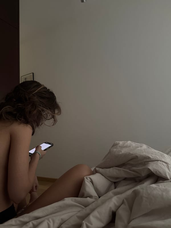Person Uses Smartphone in Bed in Warsaw