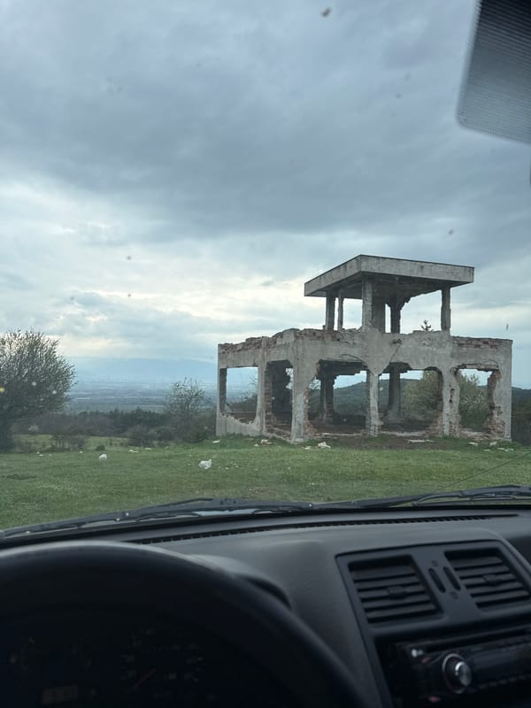 Abandoned buildings and parked SUV observed in rural Bulgaria