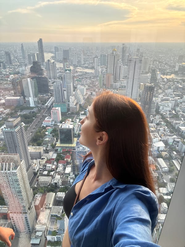 Tourists observe Bangkok skyline from high-rise observation deck