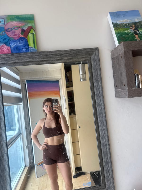 Person takes mirror selfie in athletic wear in Puebla