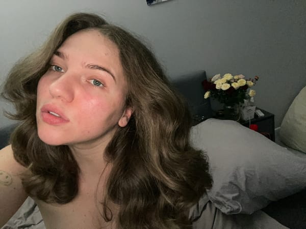 Woman rests with rose bouquets in Shcherbinka home