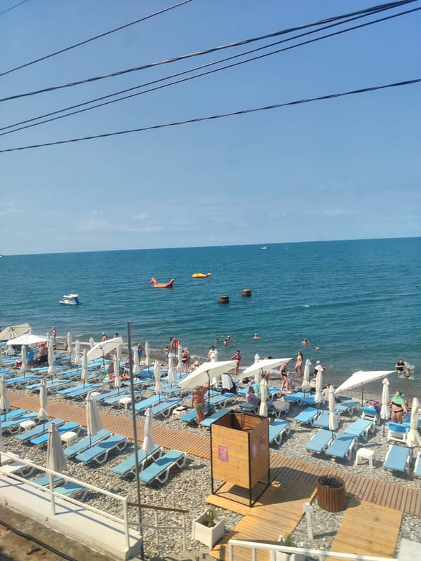 Crowded summer beach day on the Sochi Black Sea coast