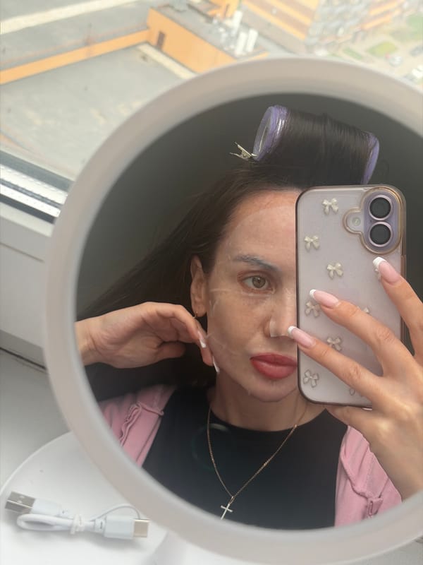 Woman documents beauty routine with selfie in Russian apartment
