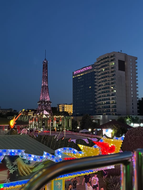 Varna fairground at night: Eiffel replica, Ferris wheel, summer evening