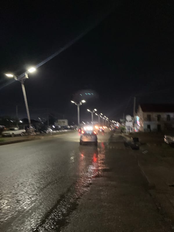 Night street food stall operates on wet streets in Rafin Par