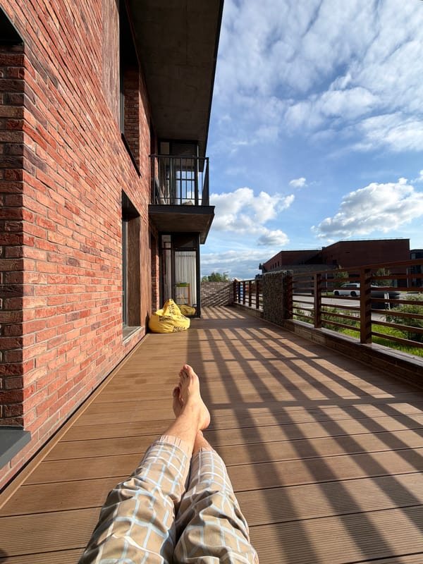Red brick stepped building with wooden deck observed in Strelna