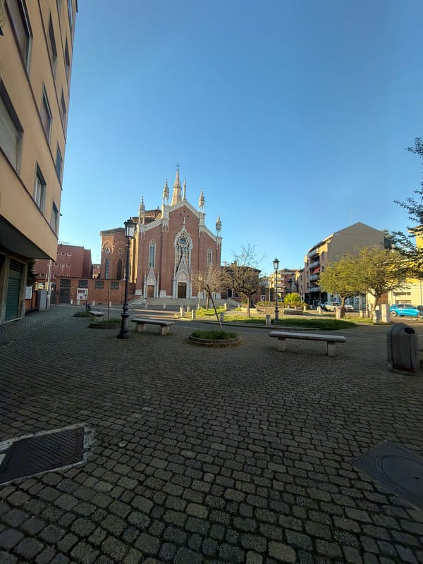 Gothic brick church in Novara under a clear blue sky