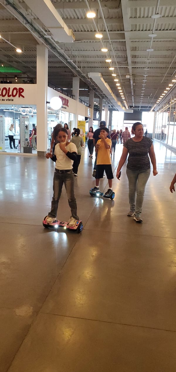 Three ride scooters inside Cabudare shopping center