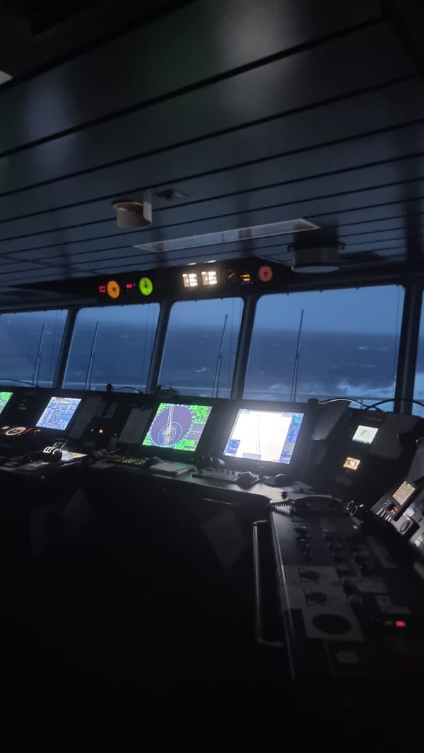 Ship's bridge navigating stormy seas, displays active