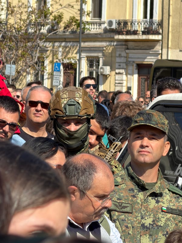 Crowd gathers in Sofia with military presence, Bulgarian flag visible