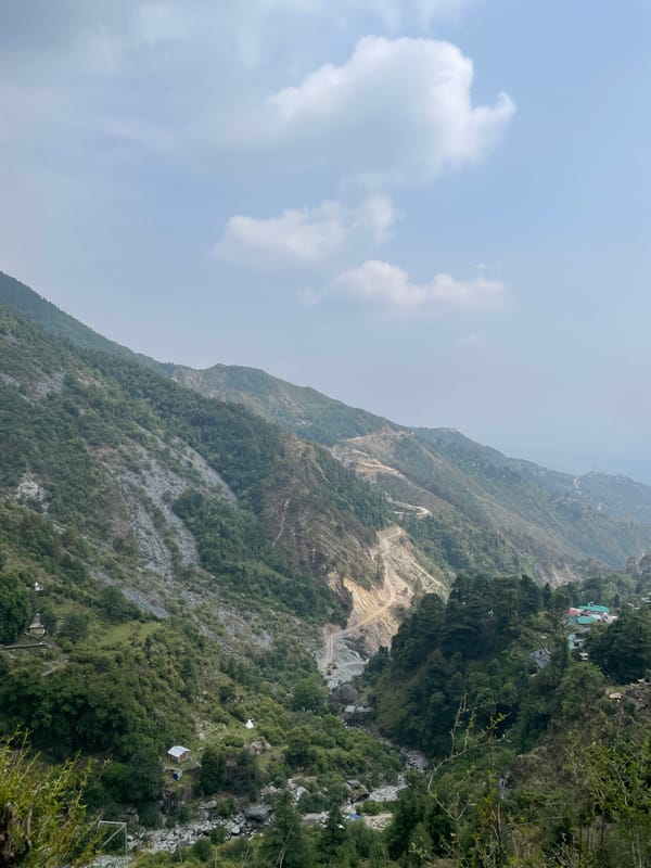 Lone hiker walks mountain paths in Bhagsu, India