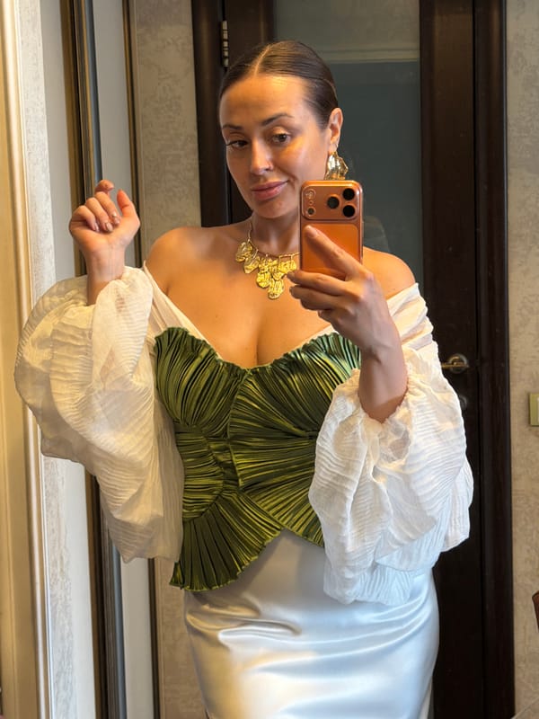 Woman takes mirror selfies in green outfit, Krasnoyarsk