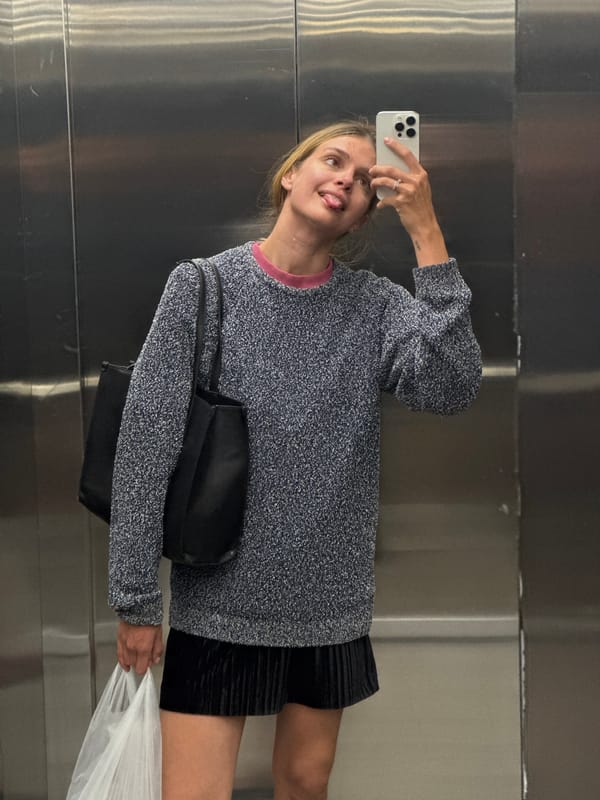 Woman Takes Selfie in Elevator