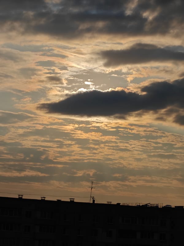 Cloudy skies, city streets, and a sleeping cat in Rubtsovsk