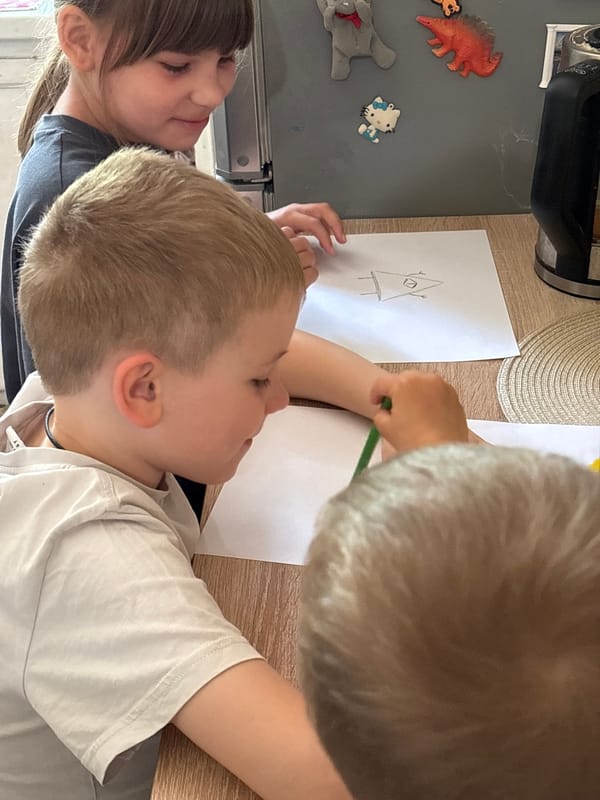 Children drawing at table in Rusanovo, Russia