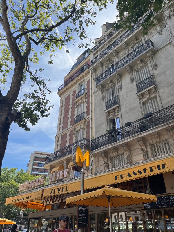 Paris church tower and café facades on a sunny afternoon