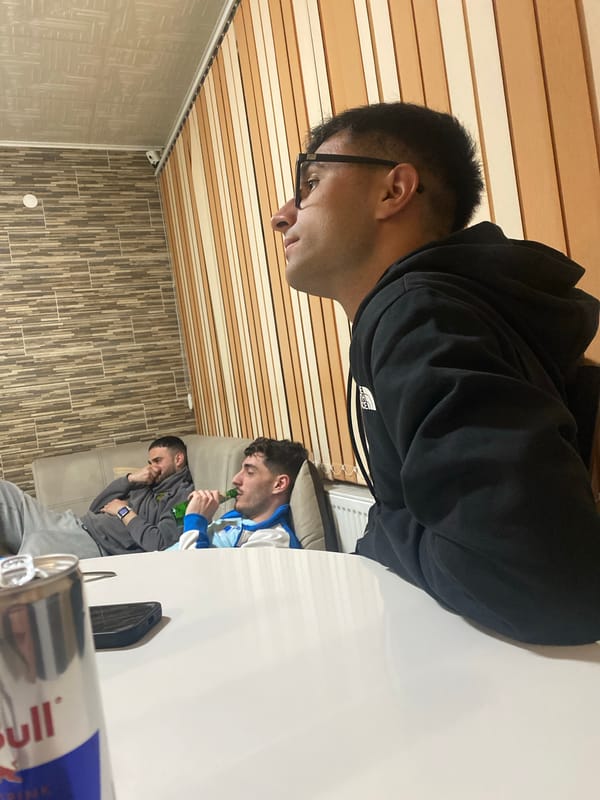 Friends watch soccer on TV during evening hangout in Bulgaria