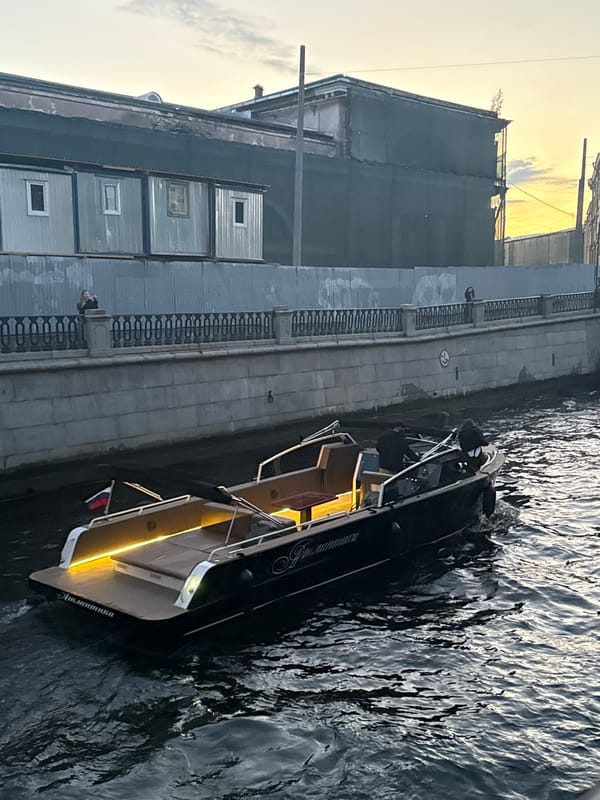 Evening canal traffic and street performances in Saint Petersburg