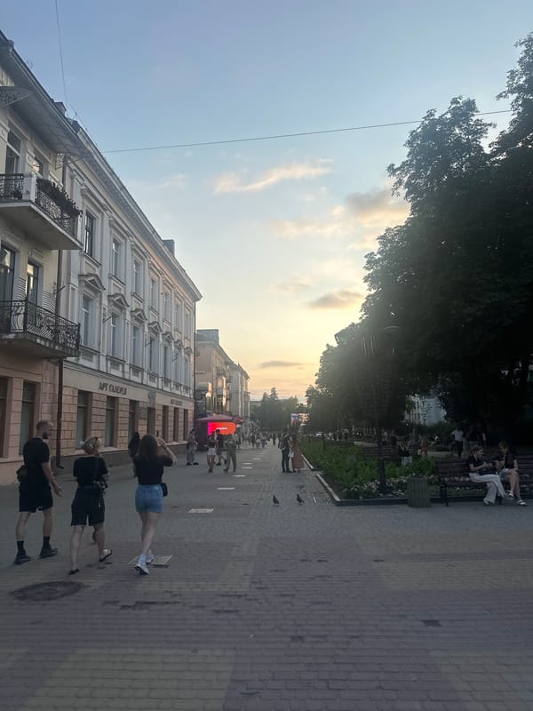 Sunset stroll through Ternopil's pedestrian center near a church