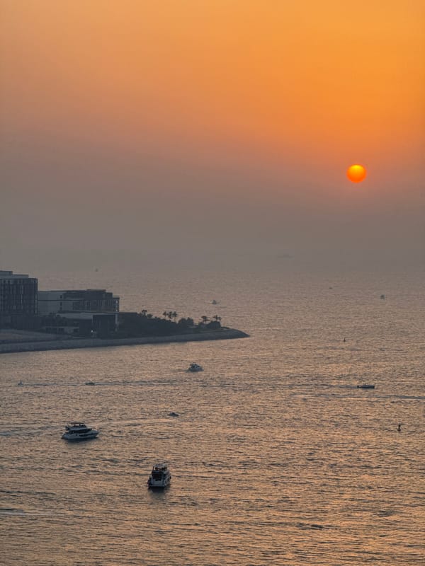 Sunset over Dubai's coast, quiet afternoon indoors