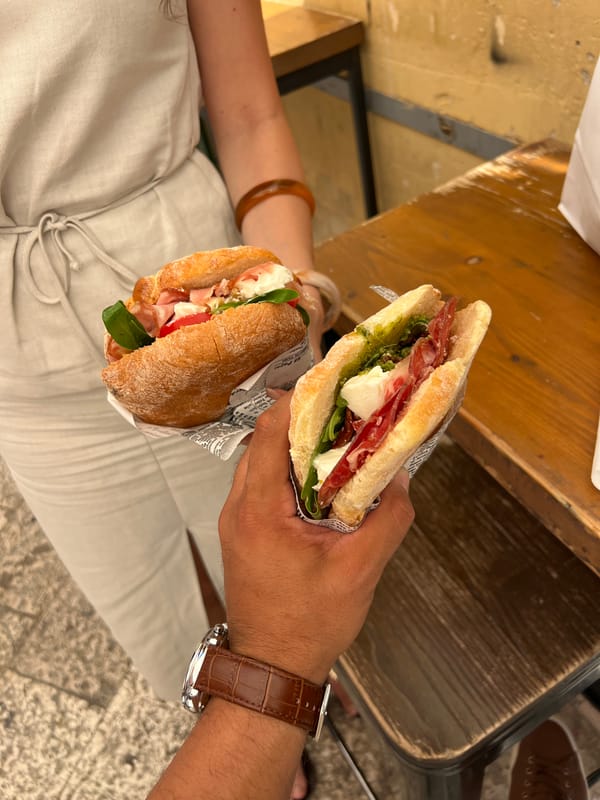 Two diners share prosciutto panini in Matera, Italy