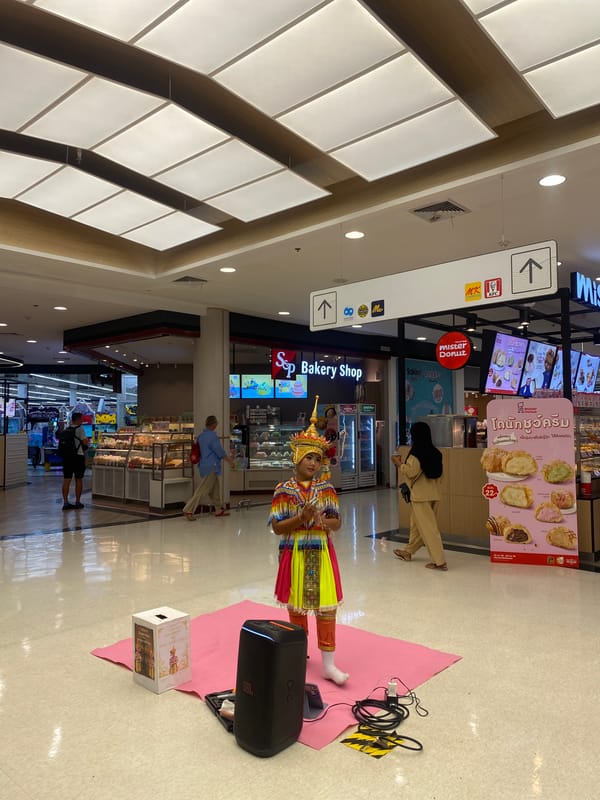 Traditional Thai dancer performs in shopping mall food court