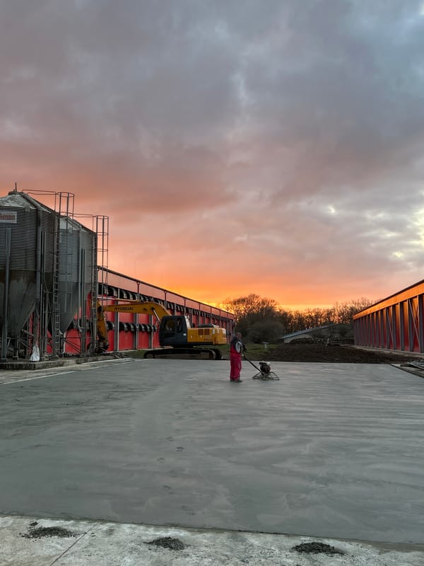 Construction worker finishes concrete at sunset in Donchevo Bulgaria