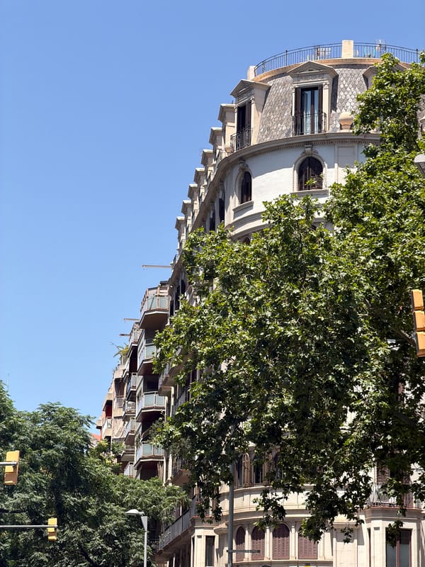 Barcelona street walk mixing historic facades, modern architecture, and luxury retail