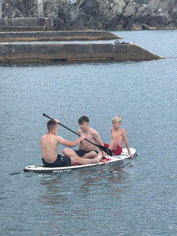 Summer day at Partenit's pebble beach, paddleboards and all